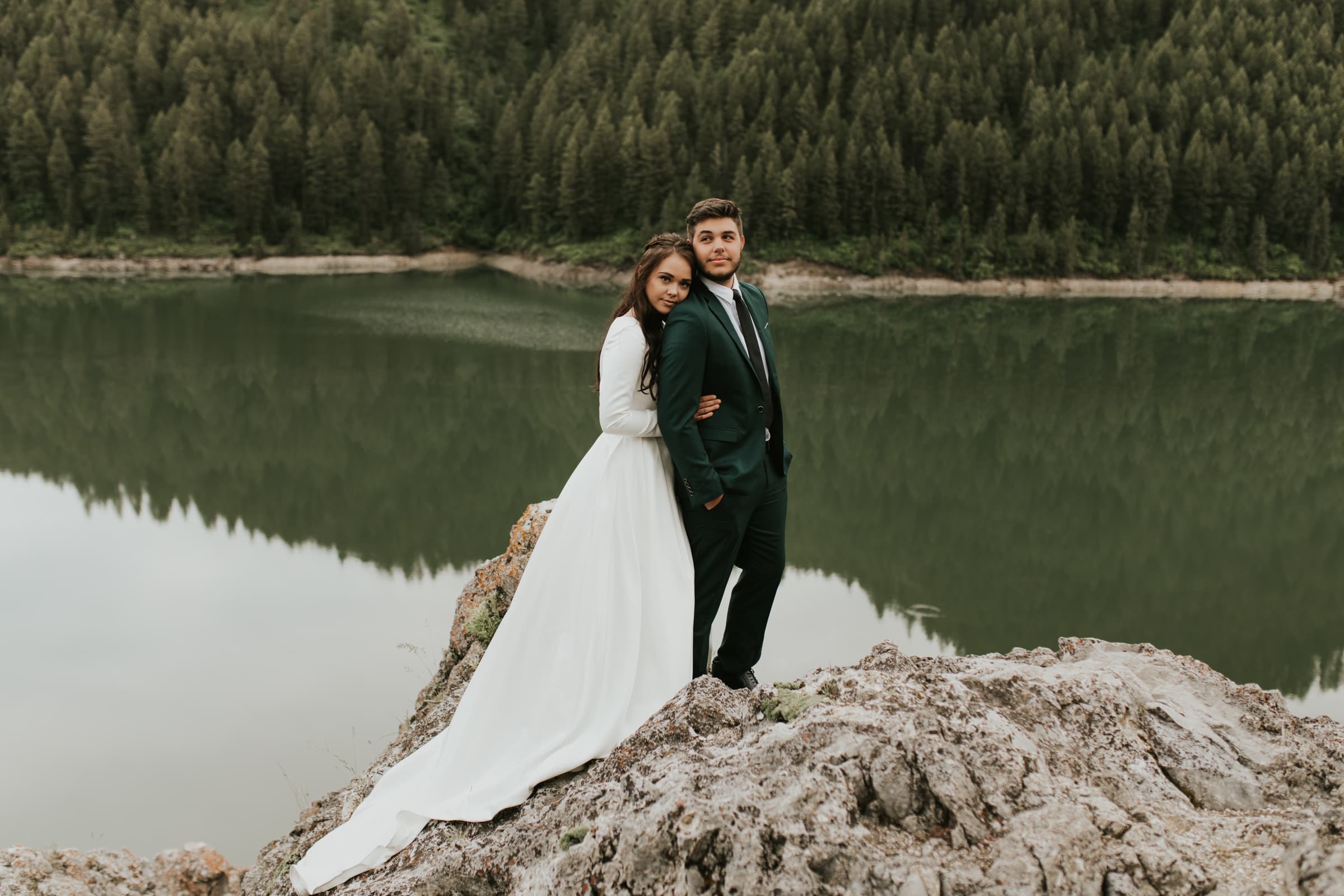 A bride and groom hugging by Palisades Reservoir in Irwin, Idaho on their wedding day.