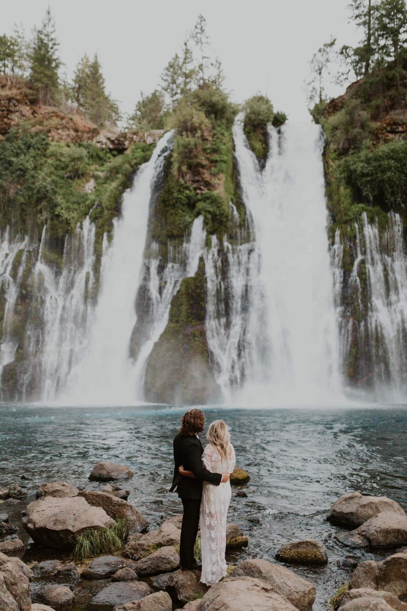 A bride and groom at Burney Falls on their elopement day in California.
