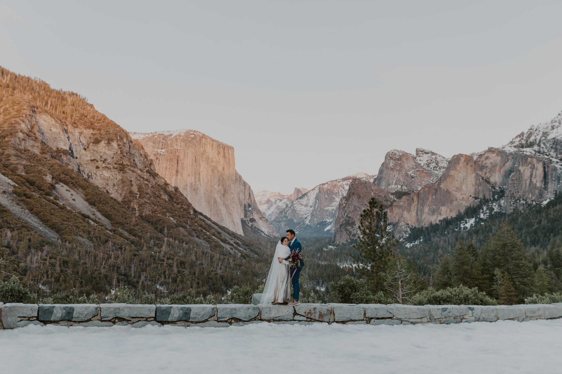 A groom kissing his brides temple at Tunnel View in Yosemite National Park.
