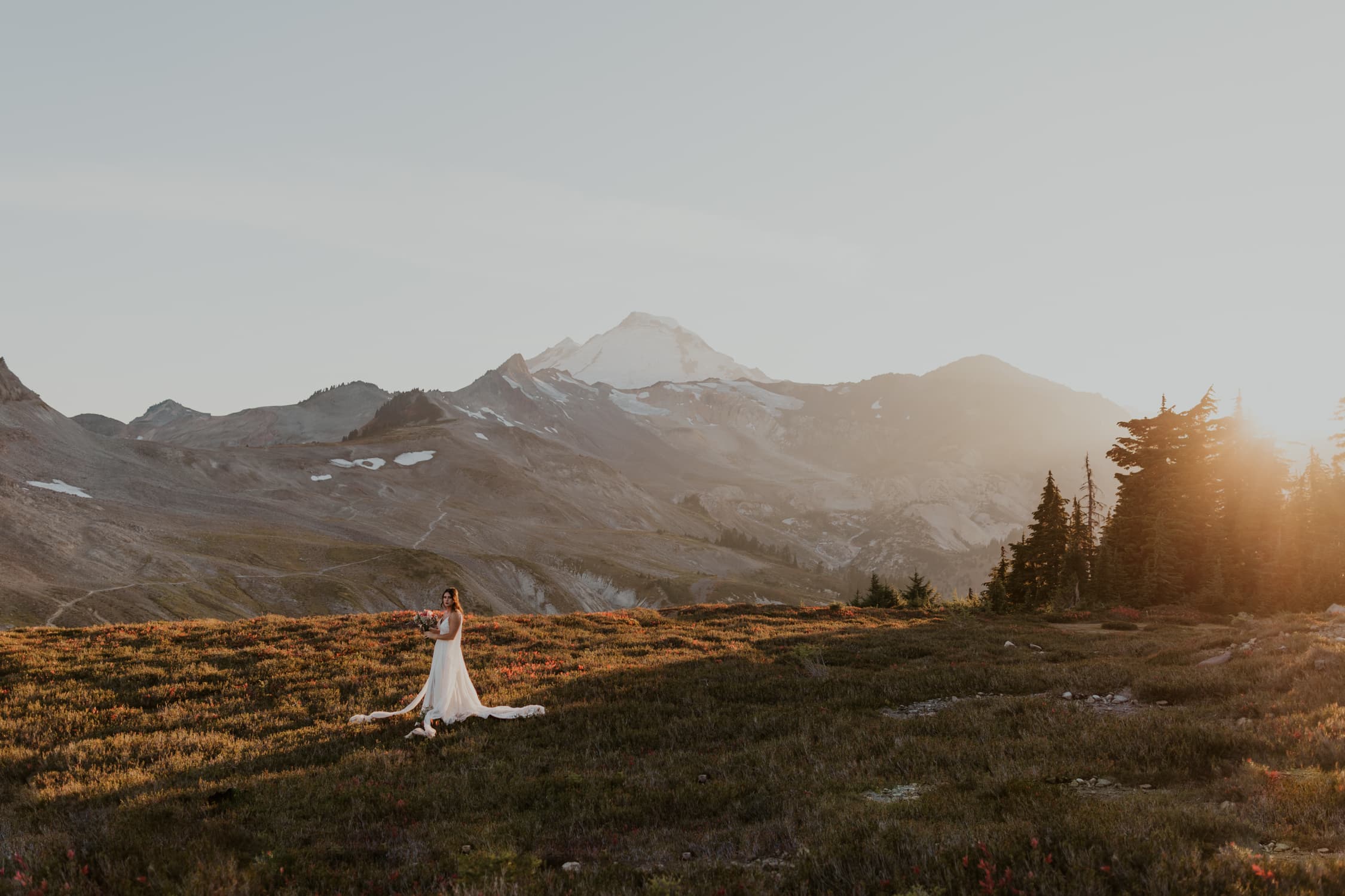 A bride standing in front of a mountain in North Cascades National Park.