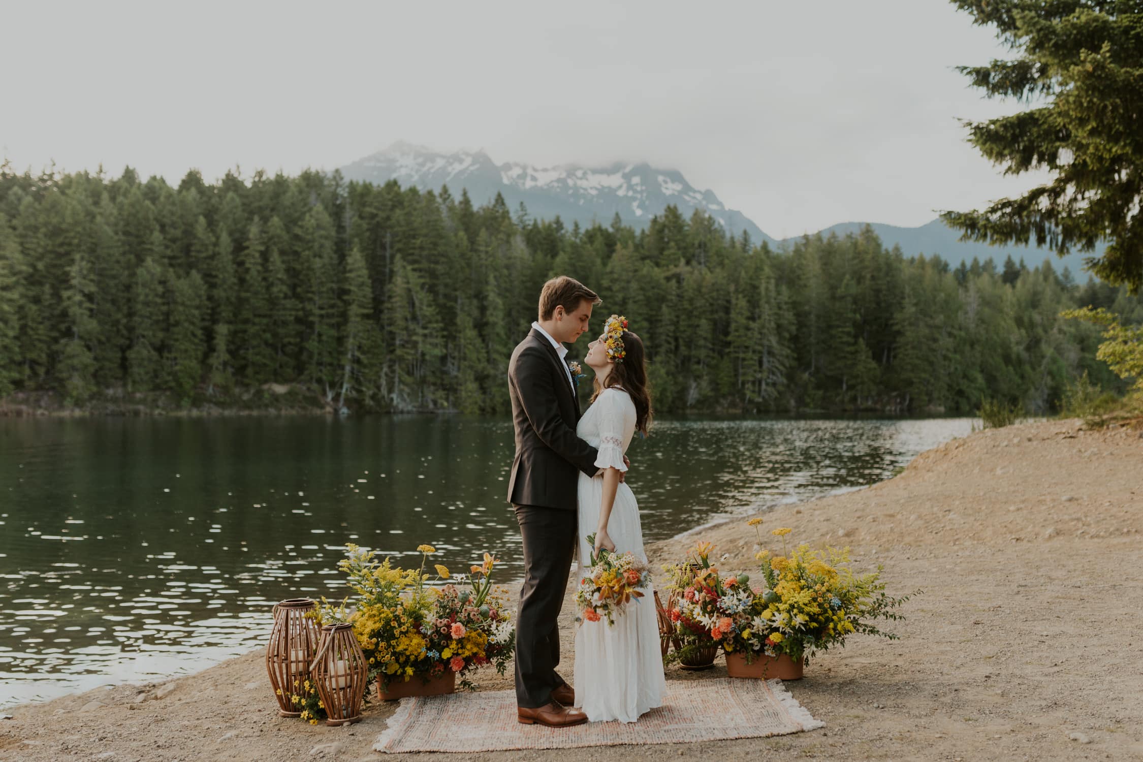 A bride and groom looking up at each other on Lake Cushman in Olympic National Park.