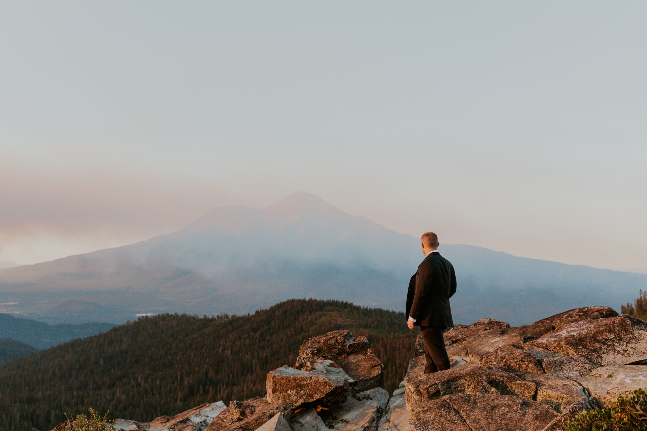 A groom looking at Mt. Shasta on his wedding day.