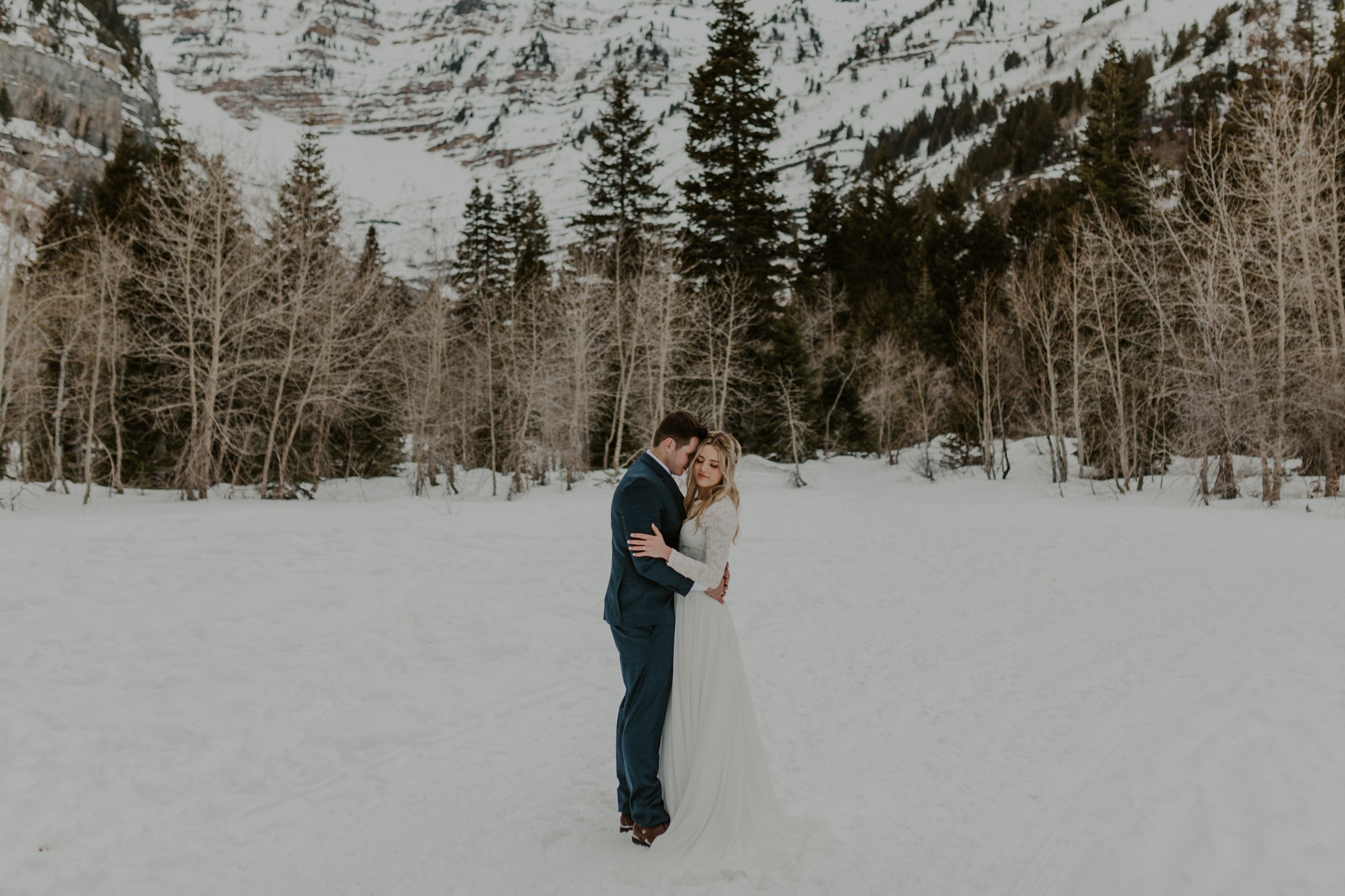 A bride and groom hugging each other during their winter elopement.