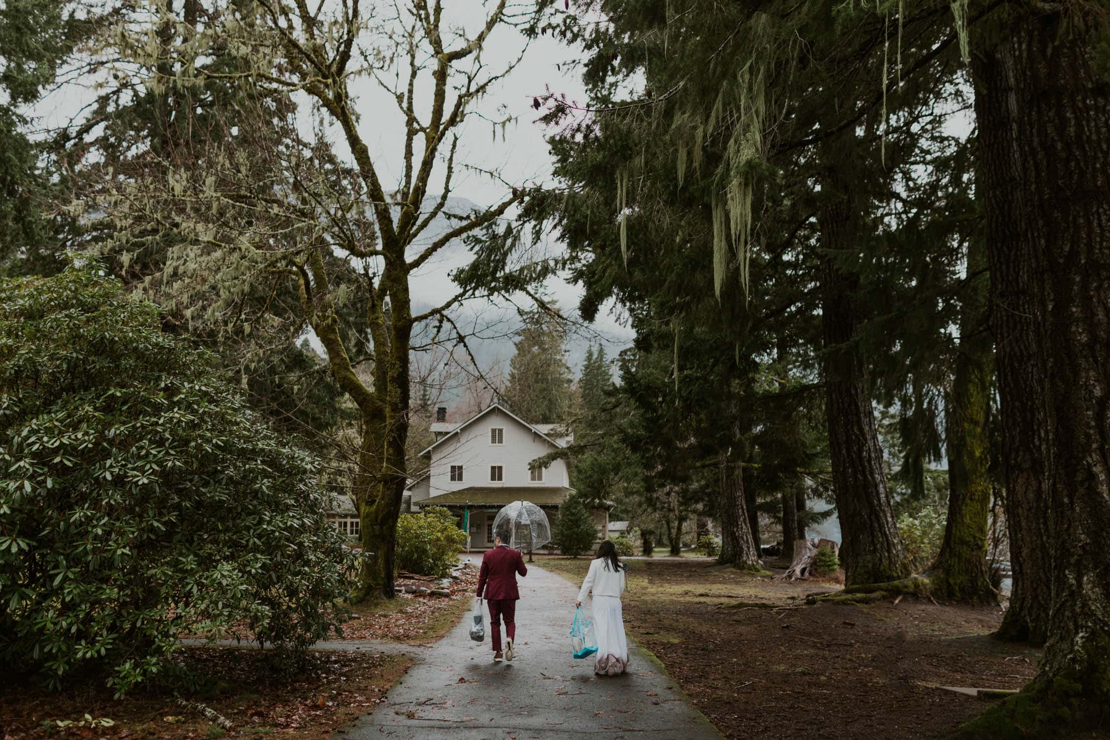 A bride and groom walking up to Lake Crescent Lodge.