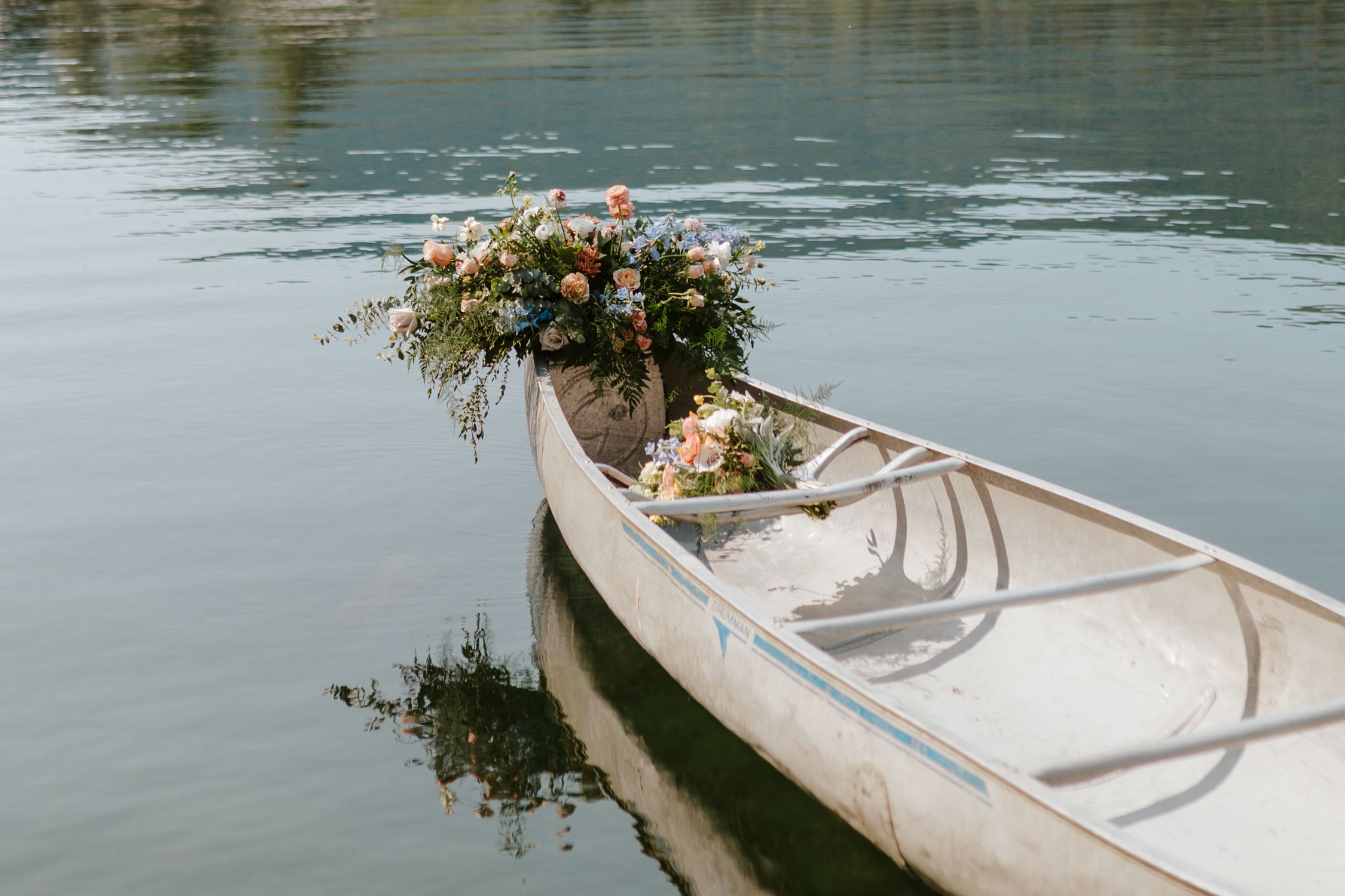 A canoe with a bouquet in it and on the bow on Lake Sutherland in Olympic National Park.