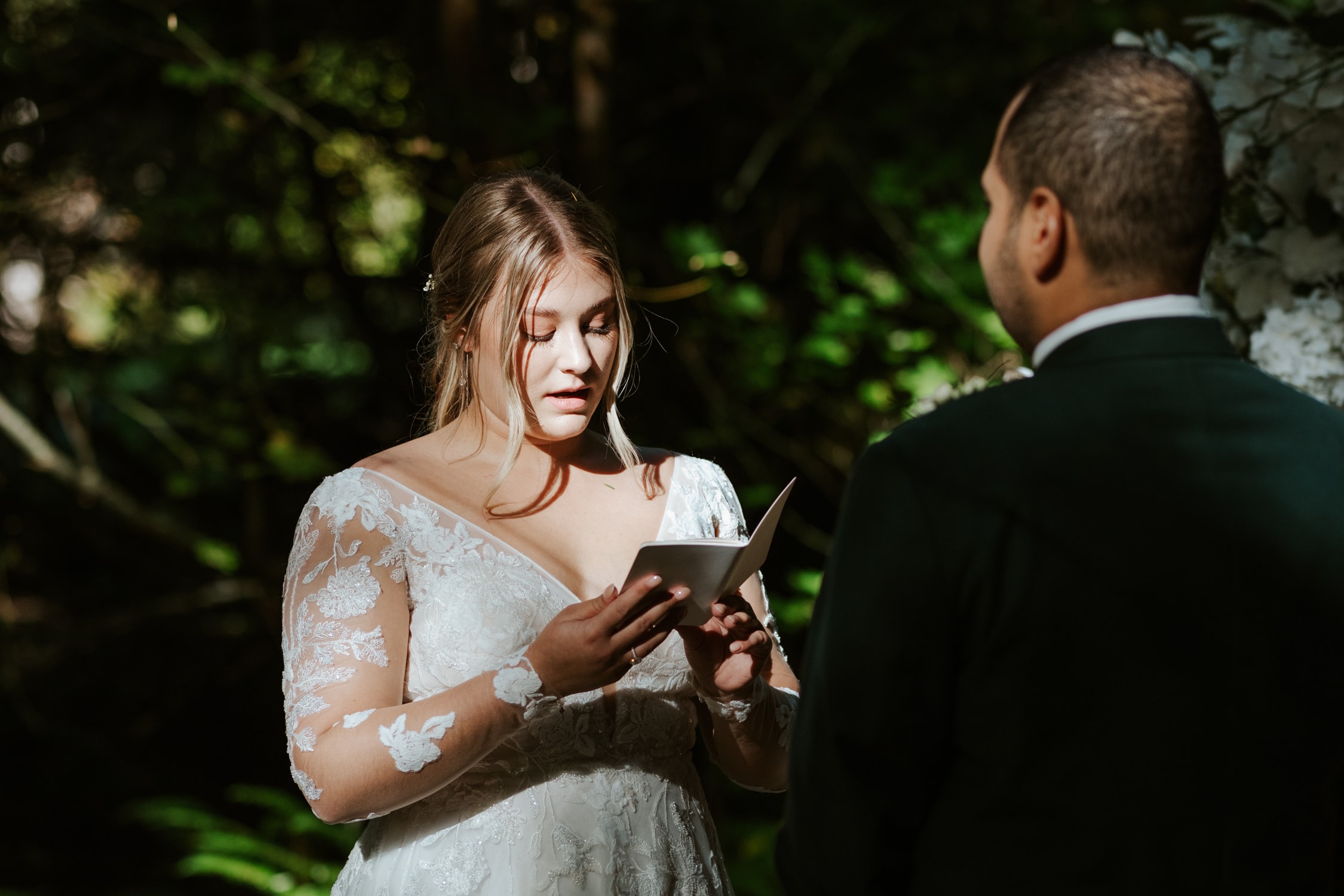 A bride reading her vows at Fern Acres in Forks, Washington.