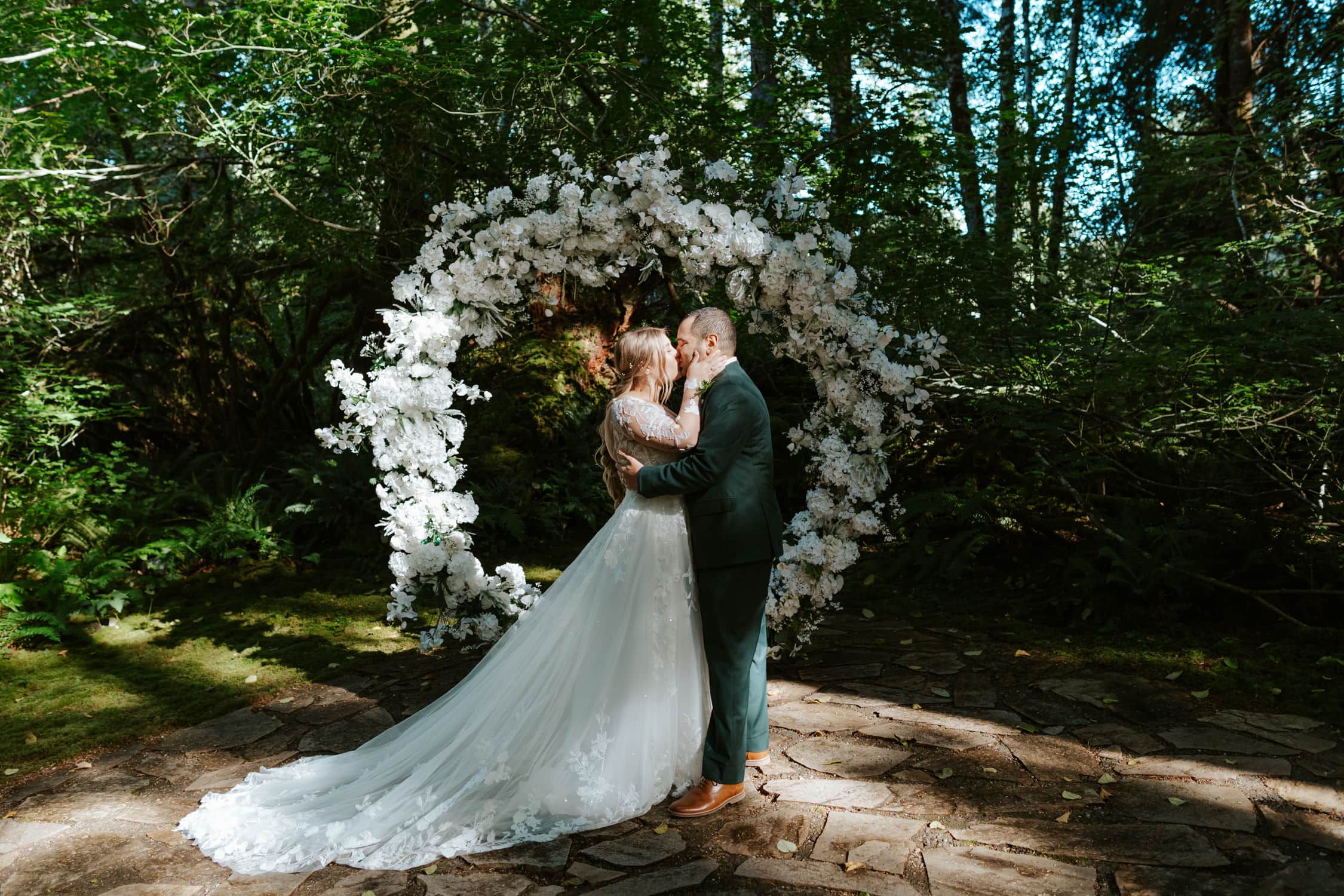 A bride and groom sharing a first kiss at the altar at Fern Acres.